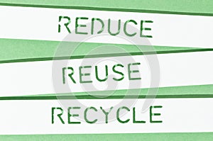 Reduce Reuse Recycle message on cut out paper strips