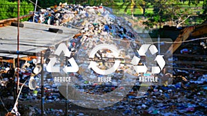 Reduce, reuse, recycle symbol on big garbage pile industry background, ecological metaphor for ecological waste management and