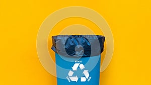 Reduce, reuse, recycle symbol with garbage bin on yellow background, Ecological concept, ecological metaphor for ecological waste