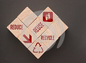 Reduce Reuse Recycle Words and icons on Wooden Cubes put in form of heart. Ecological concept