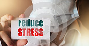 Reduce Stress Written on a Card in Hands of Medical Doctor. Healthcare relax stressfull job concept