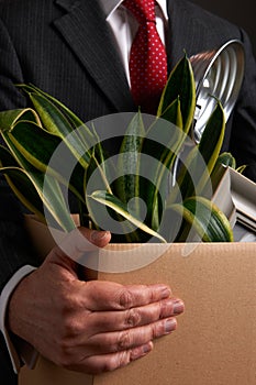 Redundant Businessman Carrying Possessions In Box photo