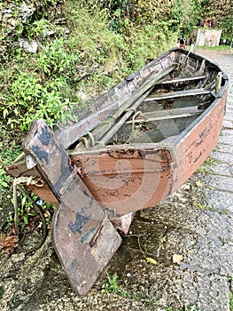 Redundant rowing boat on the quayside