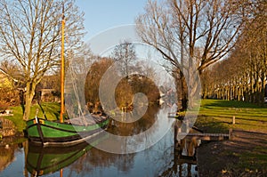 A reed barge in the canal of a Dutch village