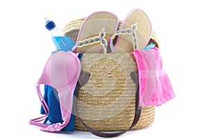 Reed beach bag filled with bikini, slippers, water etc