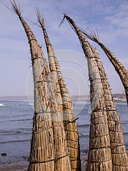 Reed canoes on Huanchaco beach, Peru photo