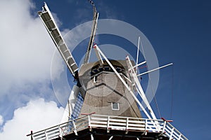 Reed hood or classical windmill against blue sky with clouds