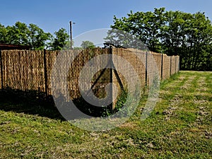 reed mat mats connected with wire mesh. attach to the wire fence