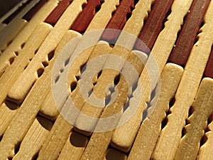 reed or wood mat. The rug is a mat under the hot. Knitted processed wood sticks with rounded edges. Close-up. Yellow  brown and