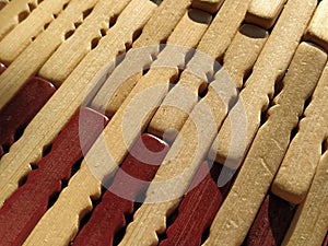 reed or wood mat. The rug is a mat under the hot. Knitted processed wood sticks with rounded edges. Close-up. Yellow  brown and