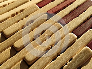 reed or wood mat. The rug is a mat under the hot. Knitted processed wood sticks with rounded edges. Close-up. Yellow  brown and