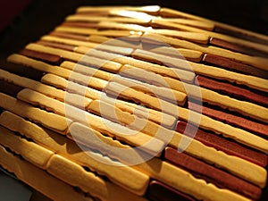 Reed or wood mat. The rug is a mat under the hot. Knitted processed wood sticks with rounded edges. Close-up. Yellow, brown and