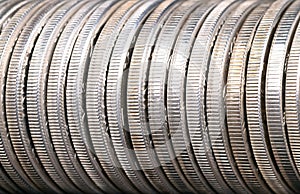 Reeded edges of silver coins in a row, close-up, from above