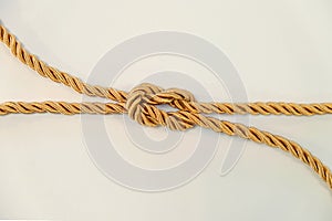 Reef knot or square knot by golden color rope