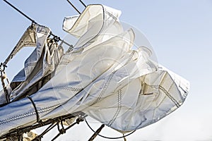 Reefed sails and blue sky