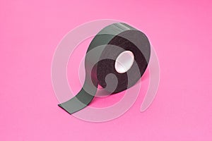 Reel of double-sided tape on a pink background, close-up, double-sided adhesive tape, element