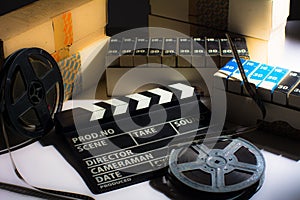 Reel with film and cinema clap