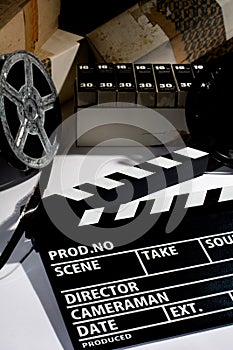 Reel with film and cinema clap