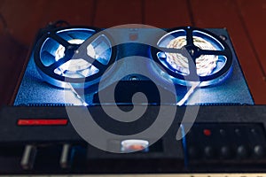 Reel to reel audio tape recorder with blue led light strip photo