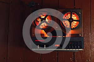 Reel to reel audio tape recorder with orange led light strip