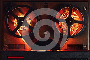 Reel to reel audio tape recorder with orange led light strip