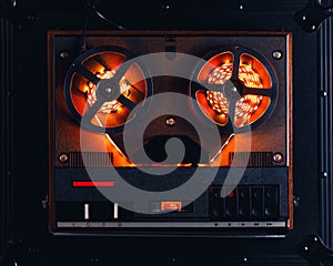 Reel to reel audio tape recorder with orange led light strip