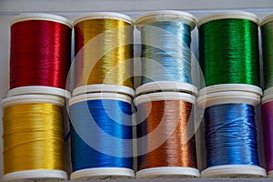 Reels of colored threads for needlework and sewing