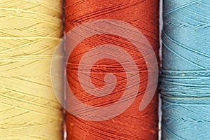 Reels or spools of multicolored sewing threads. Threads of all c