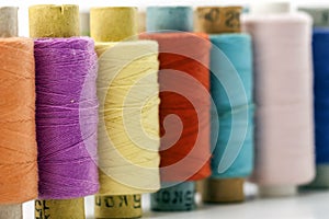 Reels or spools of multicolored sewing threads. Threads of all c