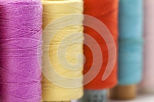 Reels or spools of multicolored sewing threads. Threads of all c