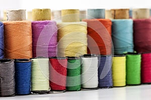 Reels or spools of multicolored sewing threads. Threads of all c