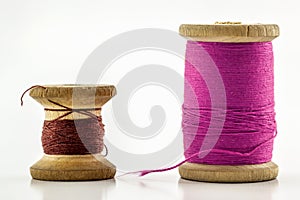 Reels or spools of multicolored sewing threads. Threads of all colors. Shallow depth of field. Close-up macro shot