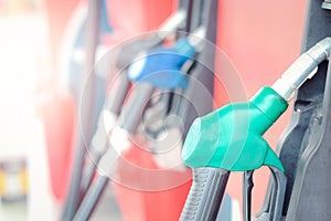 Reen petrol pump filling nozzles at gas station, fuel gasoline dispenser
