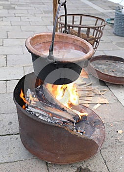 reenactment with bonfires and an old cauldron with boiling water