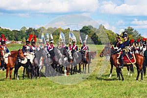 Reenactors dressed as Napoleonic war French soldiers ride horses