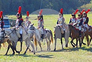 Reenactors dressed as Napoleonic war soldiers ride horses