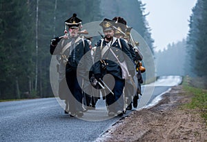 Reenactors marching to the Brill battlefield for the reconstruction of the 1812 battle of the Berezina river , Belarus.