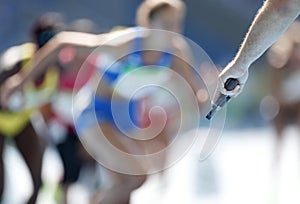 A referee fires the starter pistol for the runners of a track race