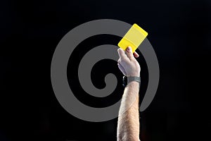 Referee hand with yellow card