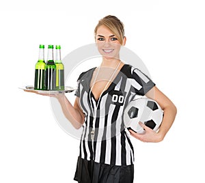 Referee holding drinks and football