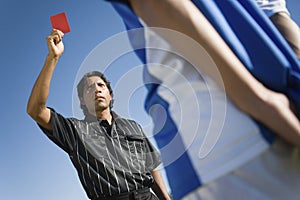 Referee Indicating Red Card To Player