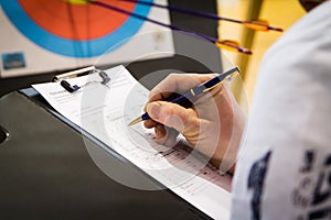 Referee Keeping Score in Archery