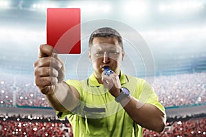 Referee showing the red card in the soccer stadium photo