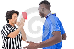 Referee showing red card to football player