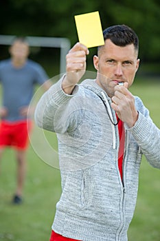 Referee showing yellow card