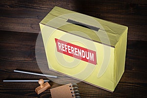 REFERENDUM. Ballot box on a wooden background