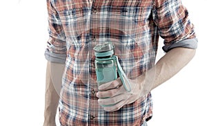 Refillable bottle. Hand hold water bottle or sport drink white background. Bottle in muscular male hand. Sport and water