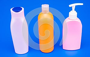 Refillable plastic liquid cosmetic packaging containers HDPE multicolor blue background, bottles