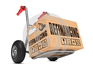 Refinancing - Cardboard Box on Hand Truck. photo
