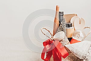 Refined Christmas gift basket for culinary enthusiats with bottle of oil, vinegar and kitchen utensils